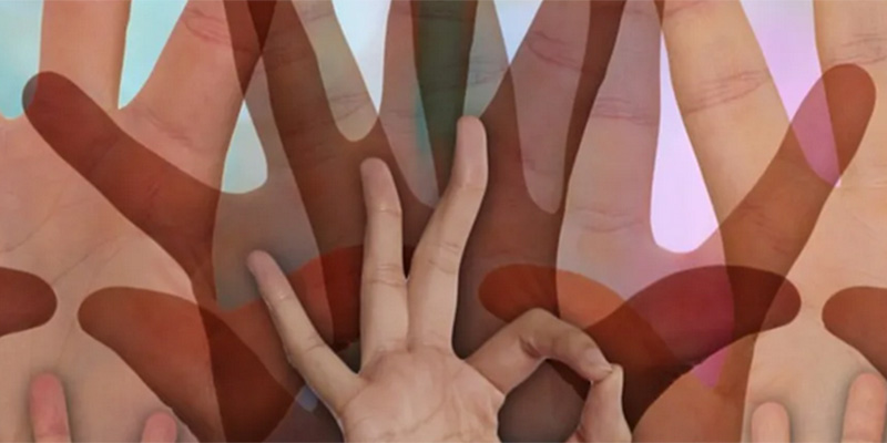 Multi-coloured hands-working together